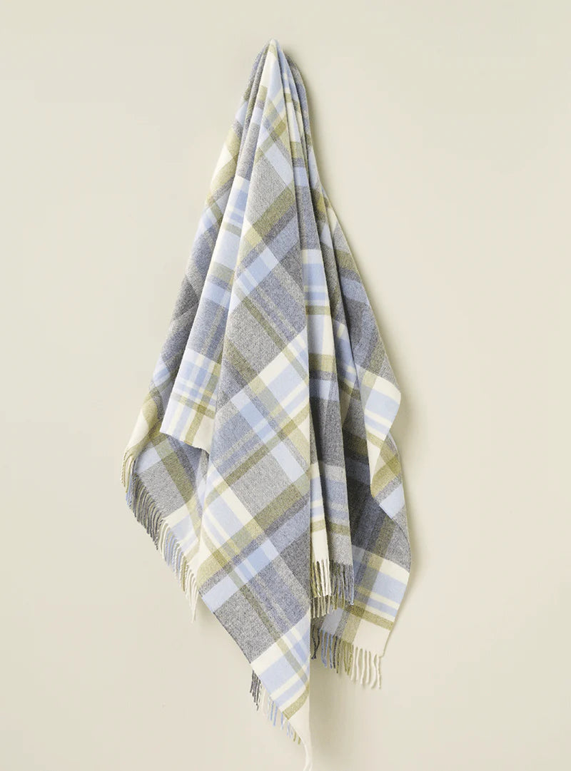 New Zealand Merino Wool Blanket in Duck Egg Blue Tartan, hanging on a cream wall.  